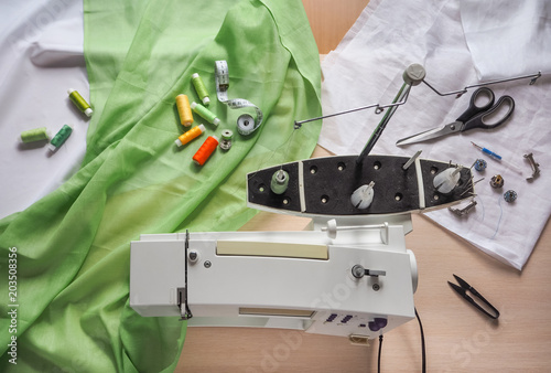 Seamstress works on a sewing machine. Stages of the production cycle on a sewing machine. photo