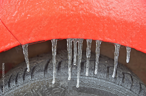 Icicle on the car's body after a frozen rain