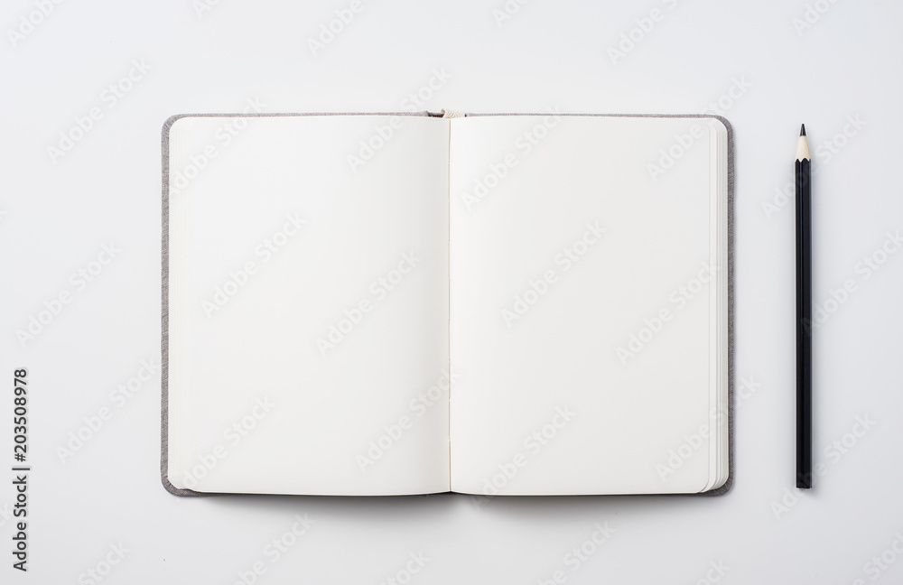 Design concept - Top view of hardcover gray linen notebook and ballpoint pen isolated on white background for mockup Design concept - Top view of hardcover gray linen notebook and ballpoint pen isolated on white background for mockup