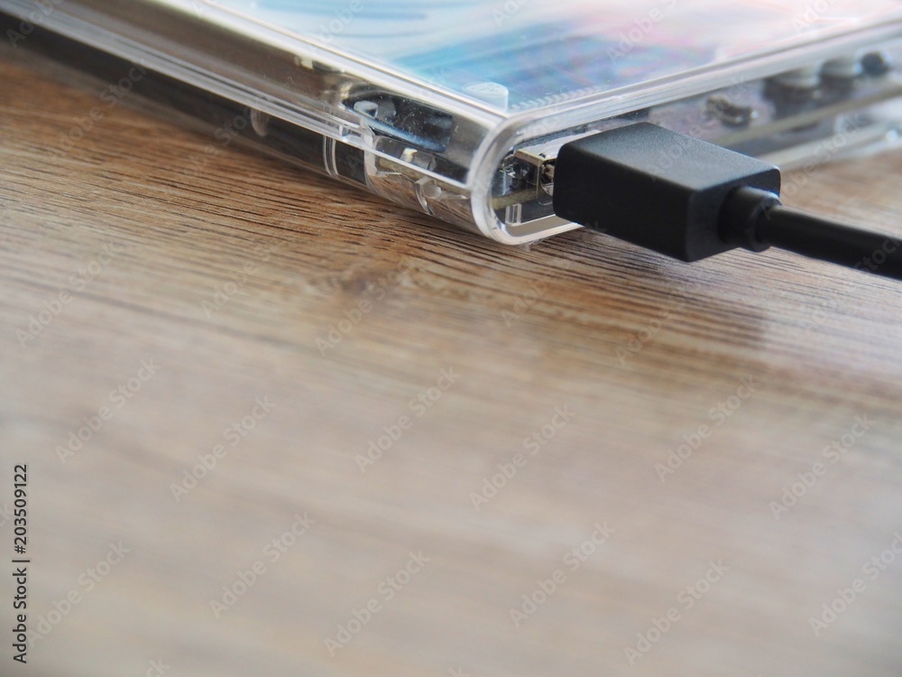 The drive is connected to a notebook computer on a wooden desk. With the concept of keeping information in the trade, it is important to the business.