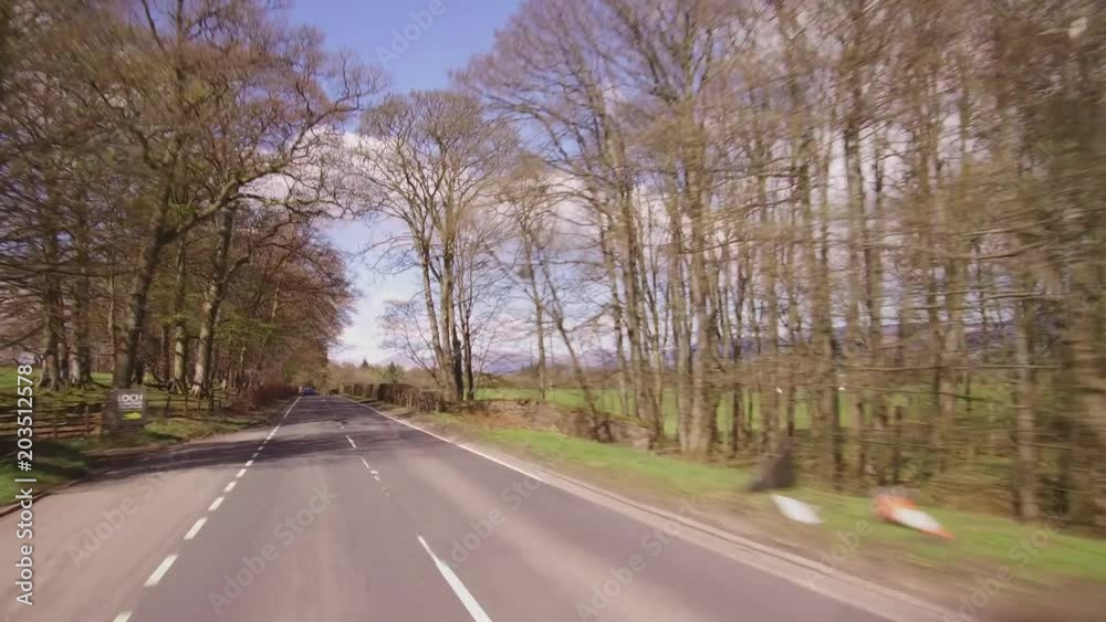 Driving into Loch Lomond and the Trossachs National Park on the A809 road. Driving into Loch Lomond and the Trossachs National Park on the A809 road.
