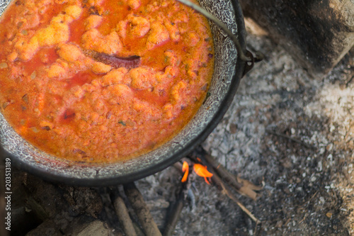 Gulyas stew boiling in a cauldron photo