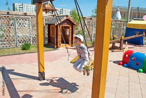 A child swinging on a swing in the park