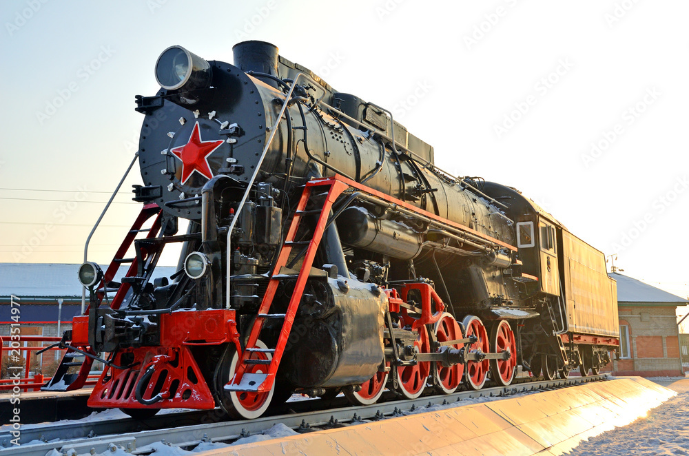 Fototapeta premium Monument to the old steam locomotive. Such steam locomotives were used in the first half of the 20th century, in the Soviet Union