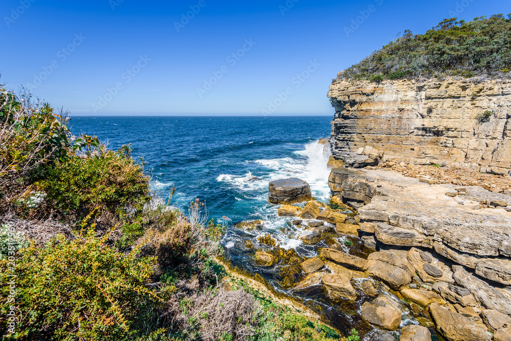 Tasman Peninsula, Tasmania, Australia: Scenic coastline of rocky cliff Tasman arch with old stone formations dramatic structures near blue wild ocean perfect hiking landscape countryside Port Arthur