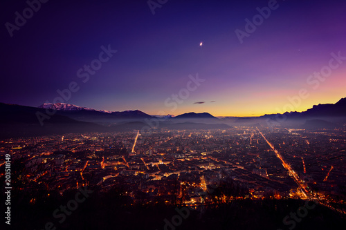Grenoble after sunset surrouned by mountains