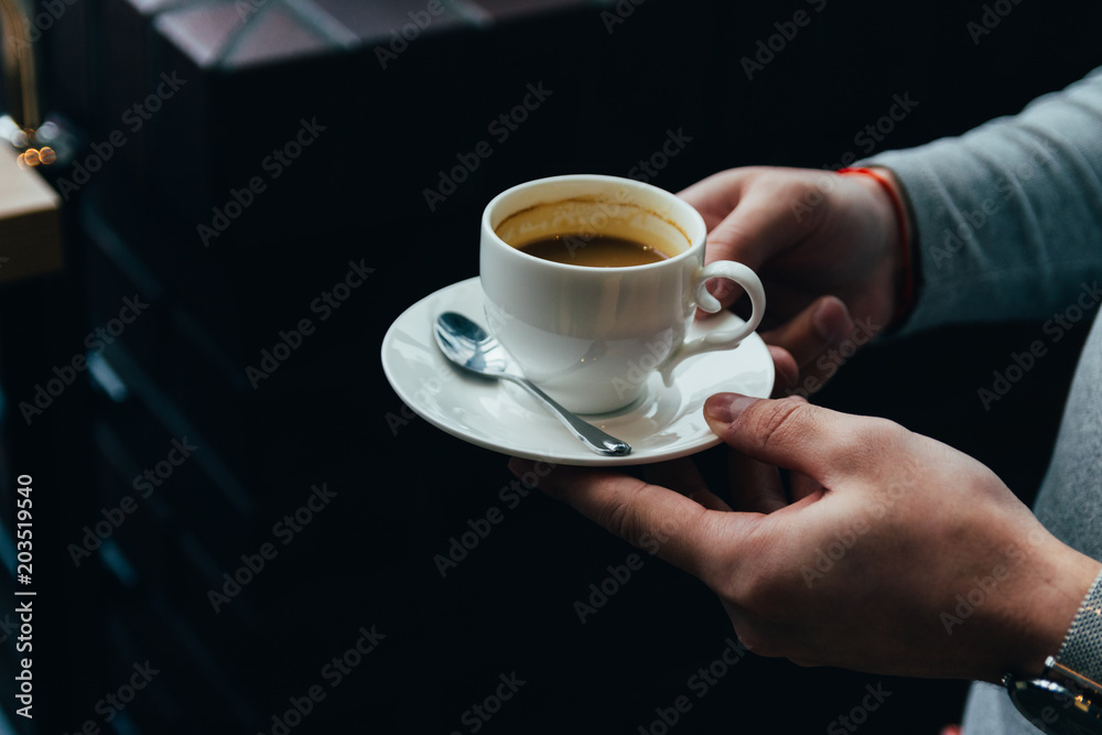 close up of man hands holding cup of coffee close up of man hands holding cup of coffee