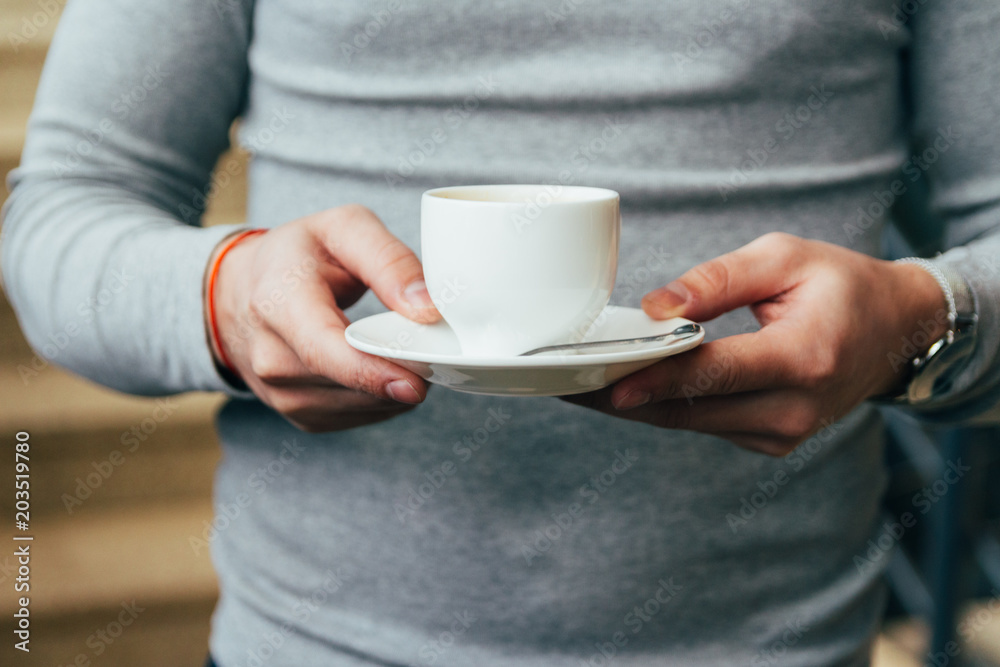 close up of man hands holding cup of coffee close up of man hands holding cup of coffee