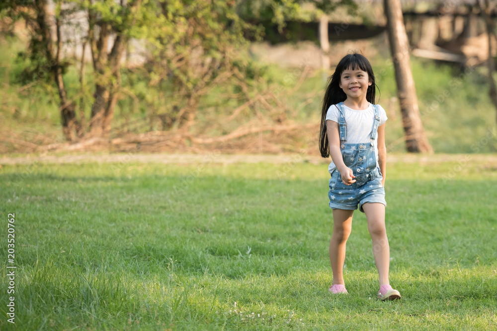 Little girl running on meadow with sunset Little girl running on meadow with sunset