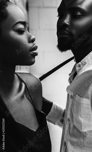Modern black man and caucasian woman in a town.
