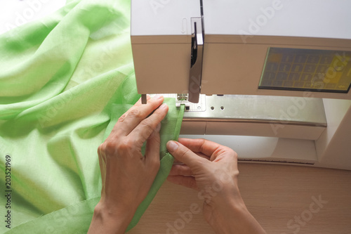 Sewing process close-up on the sewing machine. Industrial sewing machine in a private workshop at work. photo