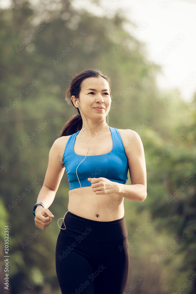 young sports woman runner running on road young sports woman runner running on road