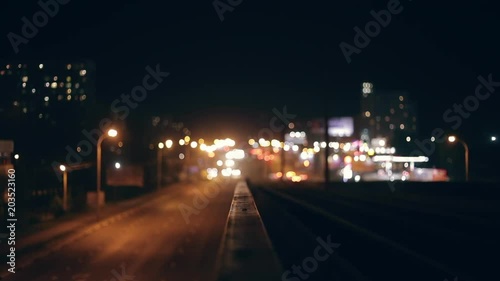 Traffic in night city, cars drivie, defocused and blurred video, bokeh urban lights scene photo