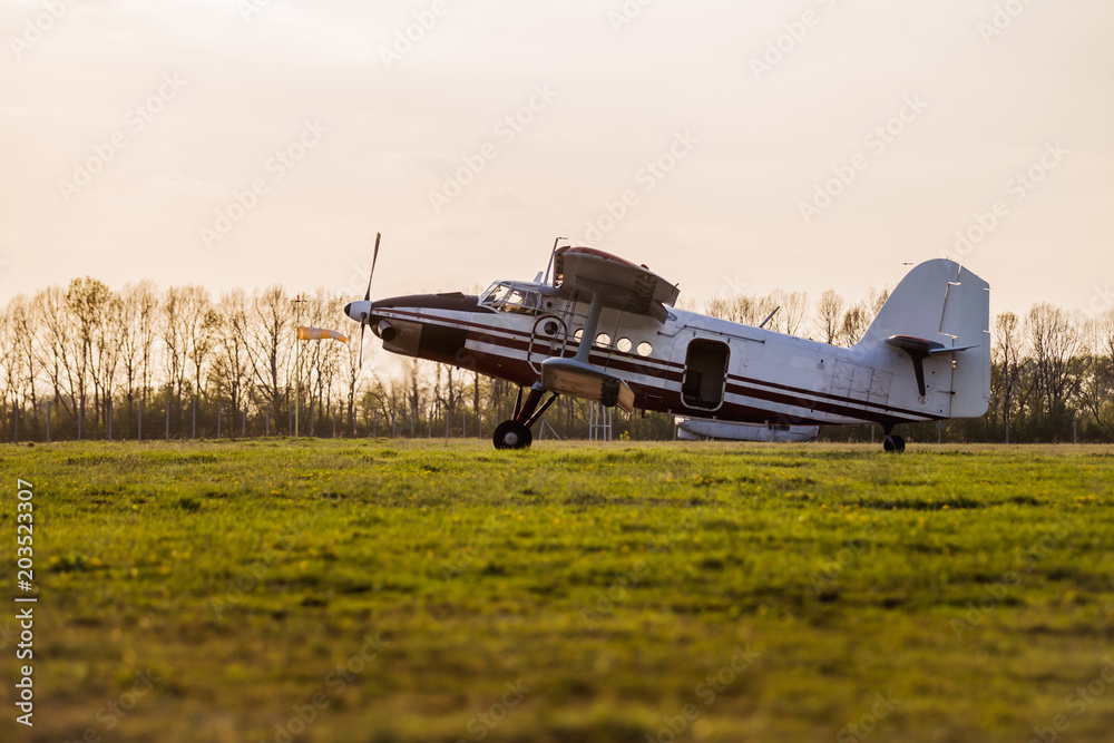Landing of an airplane on a grass field after the release of paratroopers Landing of an airplane on a grass field after the release of paratroopers