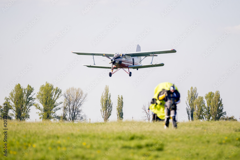 Landing of an airplane on a grass field after the release of paratroopers Landing of an airplane on a grass field after the release of paratroopers