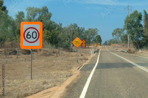 Speed restriction sign near road in the outback of Queensland in Australia