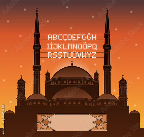 Alphabetical ramadan mahya lights over a mosque silhouette in front of sunset
