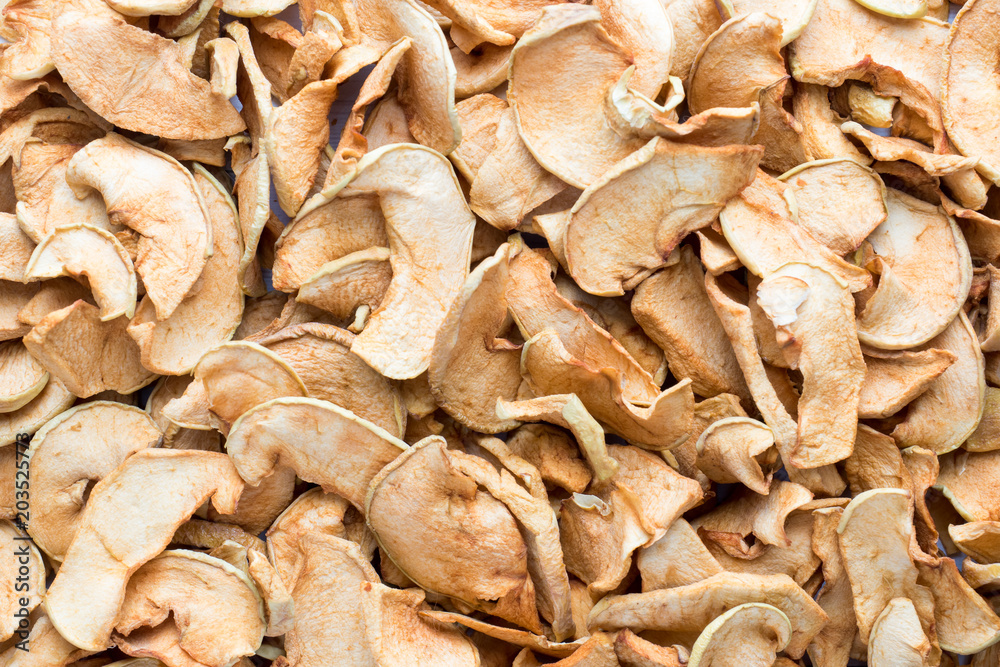 Background of sliced dried apples. Complete filling of the Autumn harvest