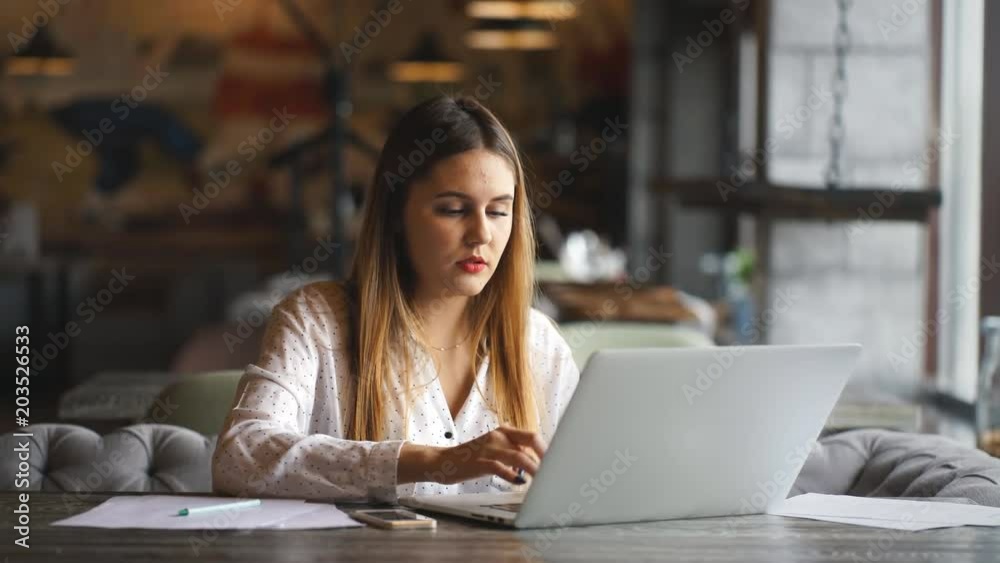 businesswoman working in a cafe and signs documents businesswoman working in a cafe and signs documents