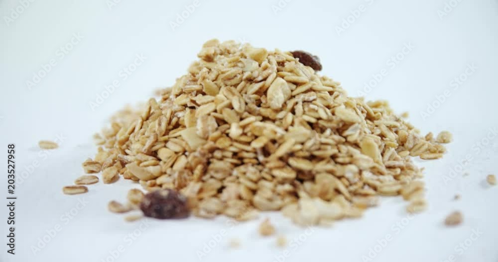 Crunchy granola scattered on white background Crunchy granola scattered on white background