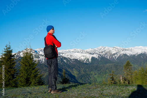 Dreaming adventurer, photographer is standing on the mountain slope