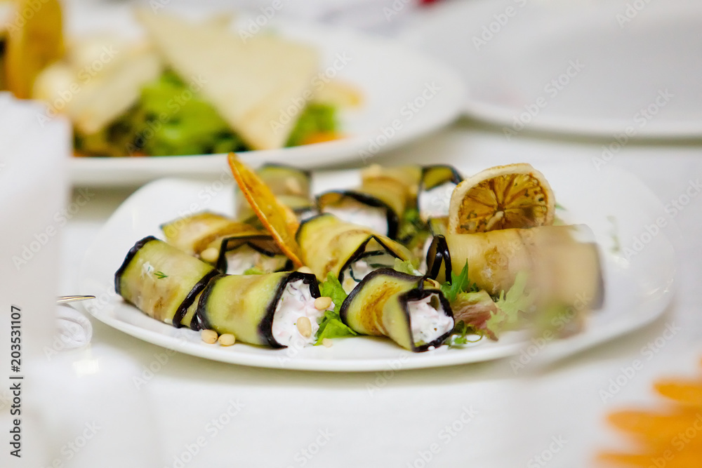 A dish of toppings, wrapped in fried eggplant. A dish of toppings, wrapped in fried eggplant.