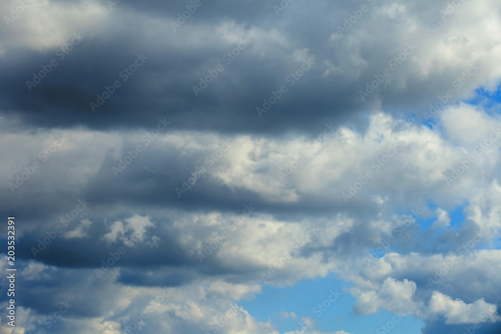 Fototapeta premium Background of gray dramatic clouds in a blue sky.