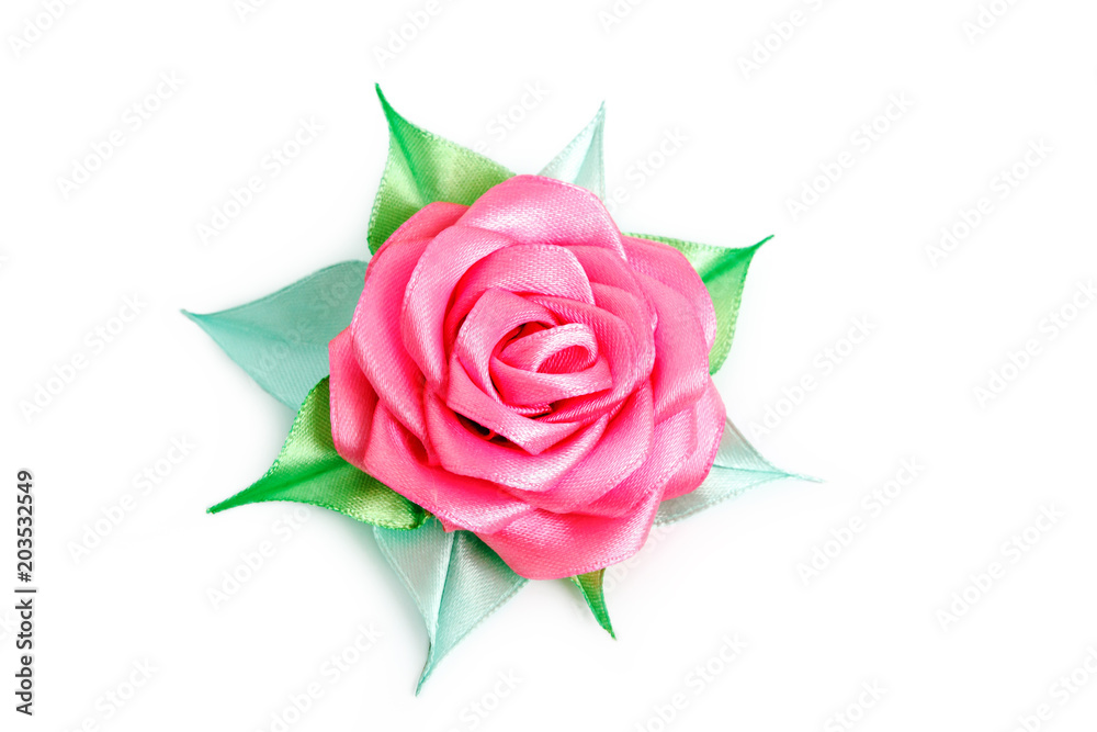 Rose with green leaves from a tape on a white background with place for text. Artificial flower made of fabric.