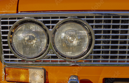 Orange old car headlight with space for text