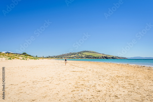Fototapeta Naklejka Na Ścianę i Meble -  Cremorne Beach, South-Arm Peninsula, Tasmania, Australia: Relaxing quiet fishing day at a sandy beach river ocean coastline perfect sunny summer weather and blue water green mountains in background