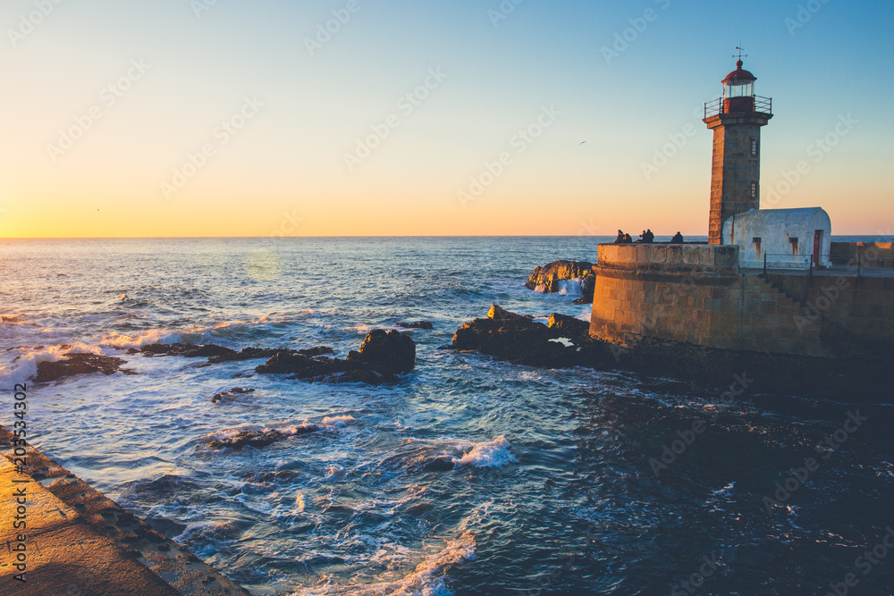 A lighthouse on the shore at the ocean