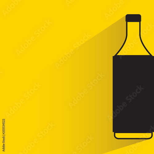 beverage bottle with drop shadow on yellow background