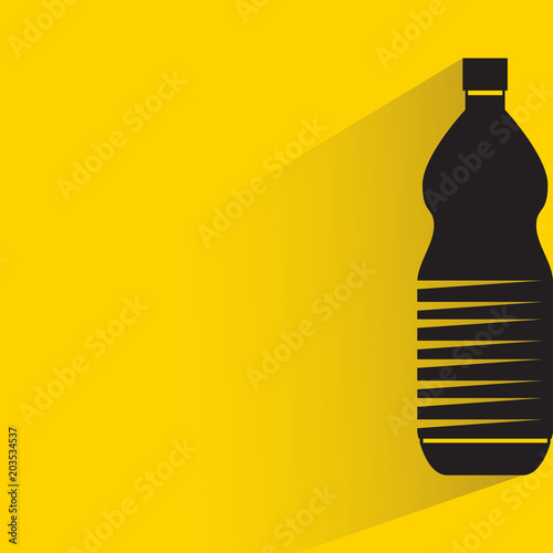 beverage bottle with drop shadow on yellow background
