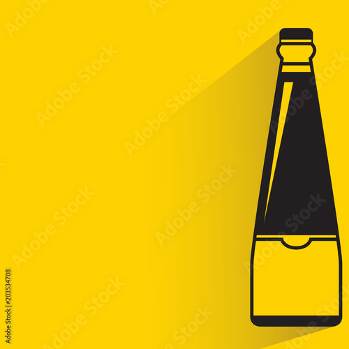 beverage bottle with drop shadow on yellow background