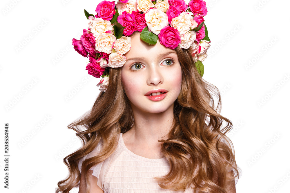 Beautiful baby girl portrait with flowers on head and curly hair.
