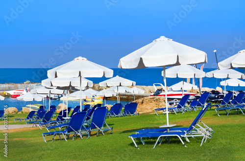 Sunbeds and umbrellas on public beach in Paphos  Cyprus