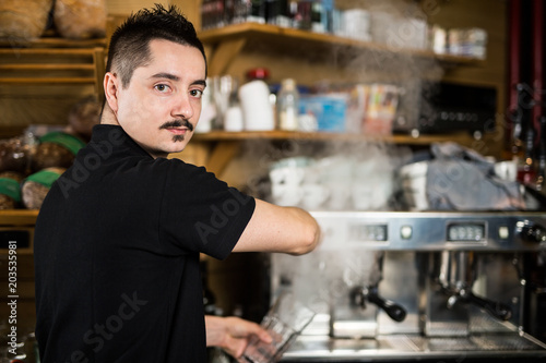 Male barista in the cafe
