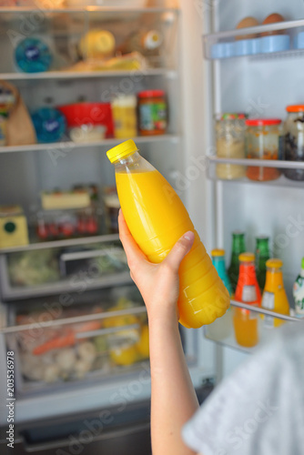 Teenage girl takes the orange juice