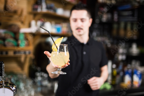 Male barista making lemonade