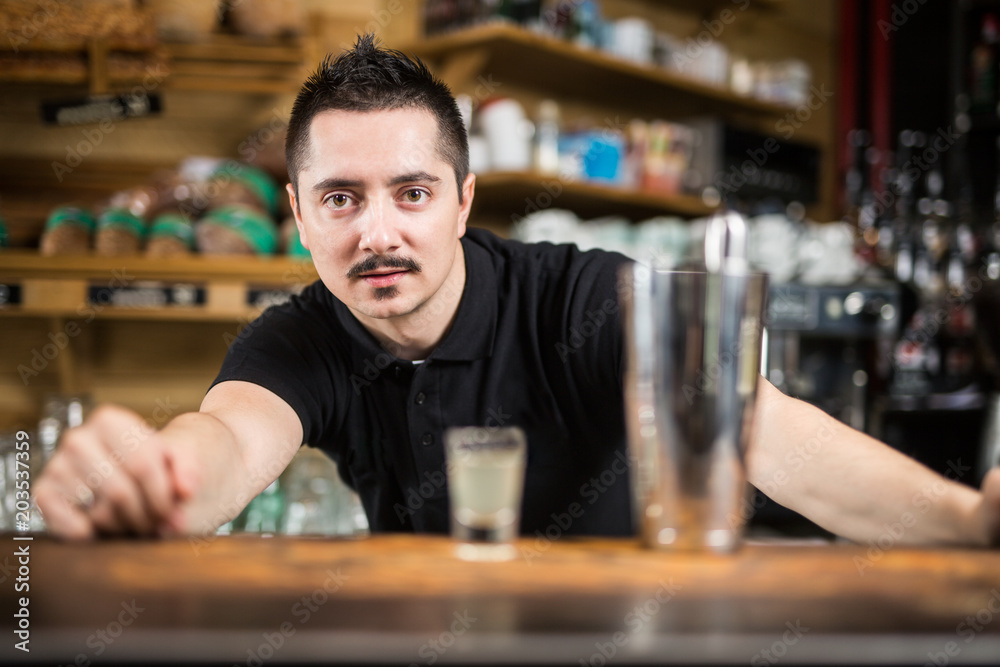 Male barista making cocktail