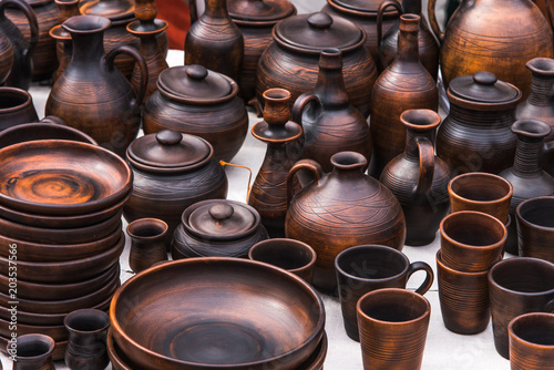 Traditional rural cups, jugs and plates of clay on the counter of a street shop