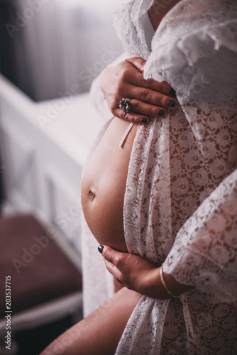 pregnant woman in white lingerie at home. Pregnancy concept.Waiting baby photo