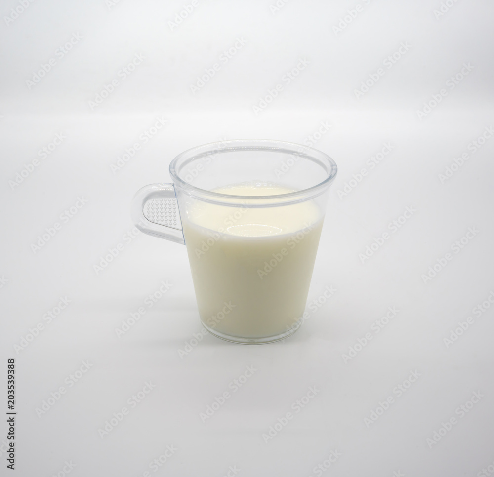 Fresh milk or soil milk in clear plastic cup with handle isolated on white Fresh milk or soil milk in clear plastic cup with handle isolated on white
