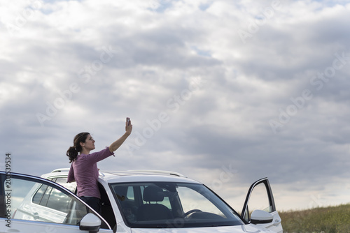 woman looking for coverage for the mobile phone in her suv car