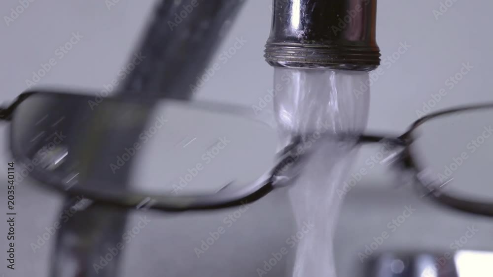 Eyeglasses under a Running Tap, Cleaning Eyeglasses, Close-Up Eyeglasses under a Running Tap, Cleaning Eyeglasses, Close-Up