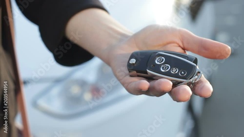 Wallpaper Mural Wife giving back auto key to her husband after divorce. Hand on car background Torontodigital.ca