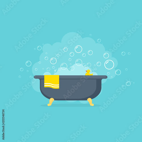 Bathtub with foam bubbles and yellow rubber duck.