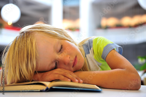 Little boy dreaming with a book