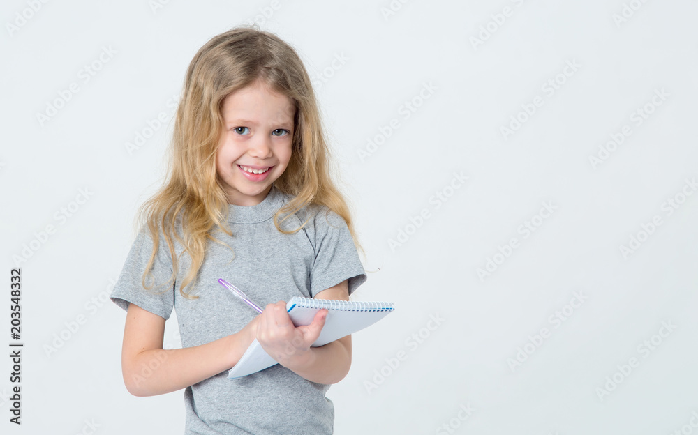Clever girl. A little girl is writing in a notebook. Clever girl. A little girl is writing in a notebook.