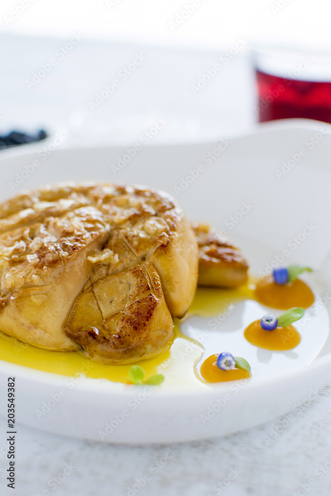 Fried Goose Liver with Apple Sauce on White Plate. Foie Gras Fine Food. Fried Goose Liver with Apple Sauce on White Plate. Foie Gras Fine Food.